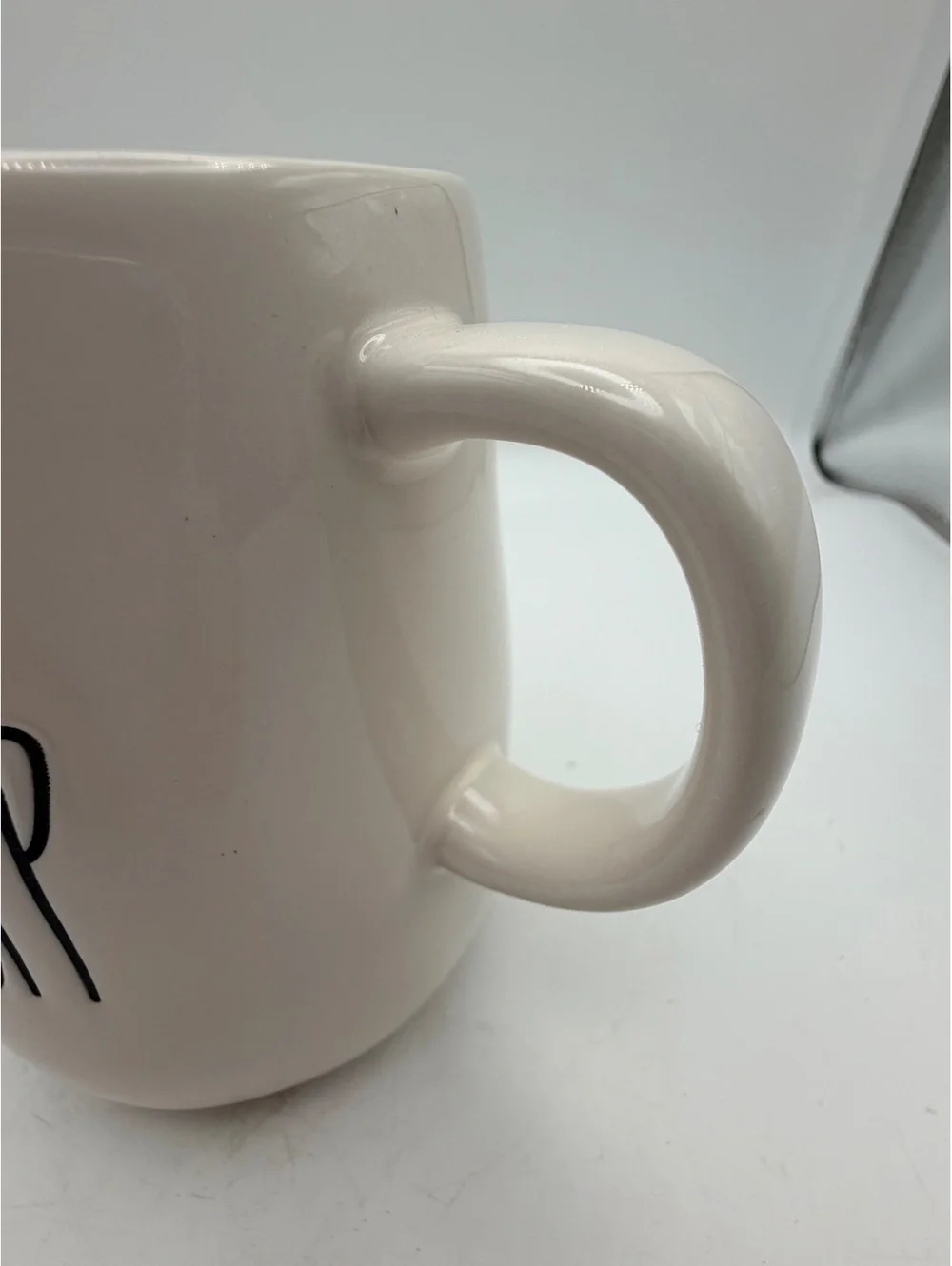 Rae Dunn white ceramic syrup pitcher.with handle. In like new condition